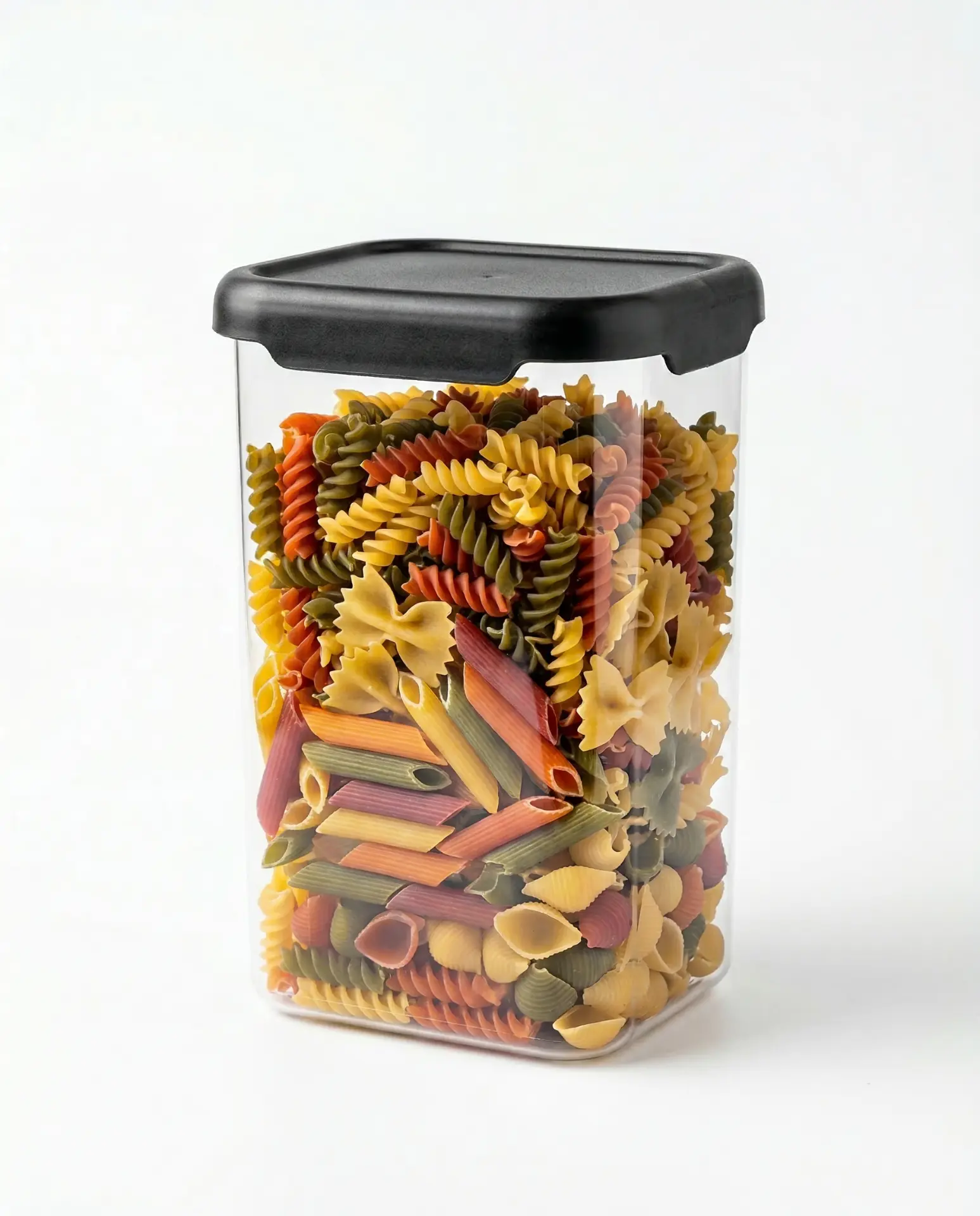 Transparent container filled with colourful pasta